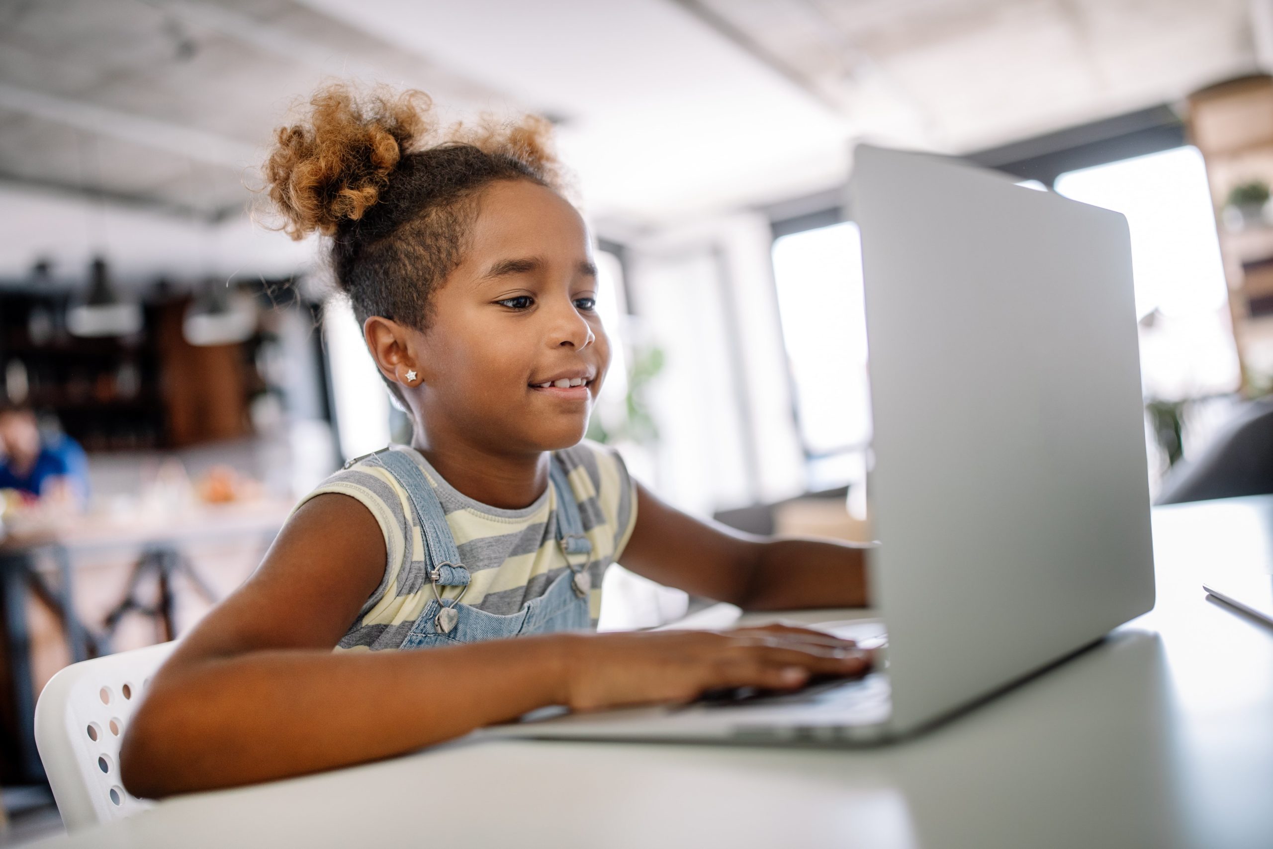 young girl of color with laptop